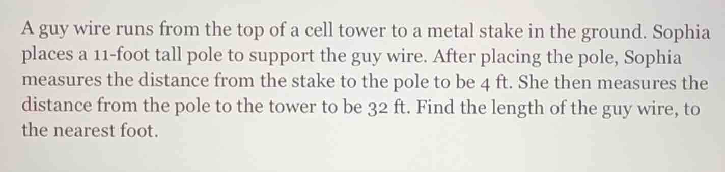 a guy wire runs from the top of a cell tower to a metal stake in the gr…