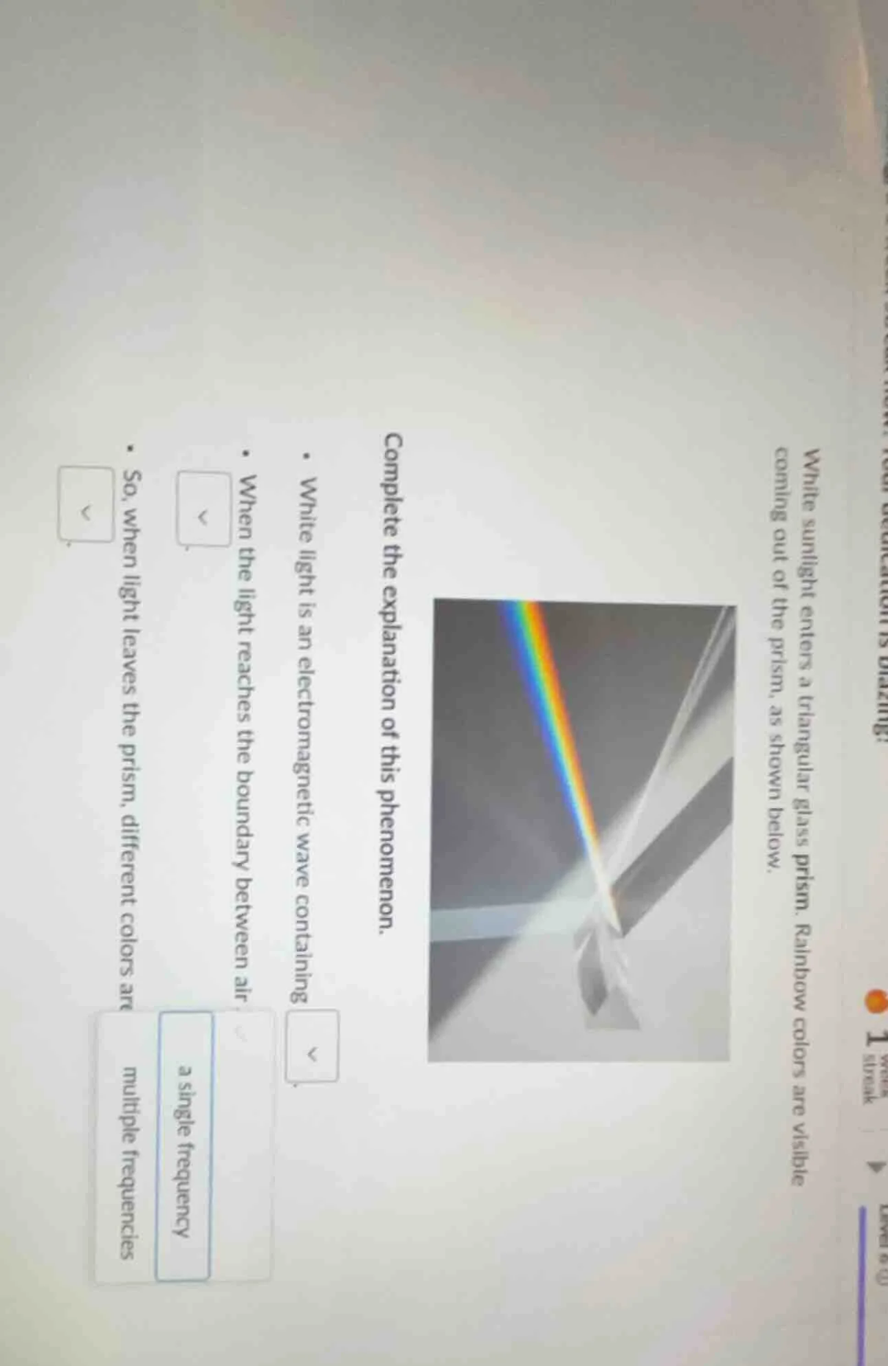 white sunlight enters a triangular glass prism. rainbow colors are visi…