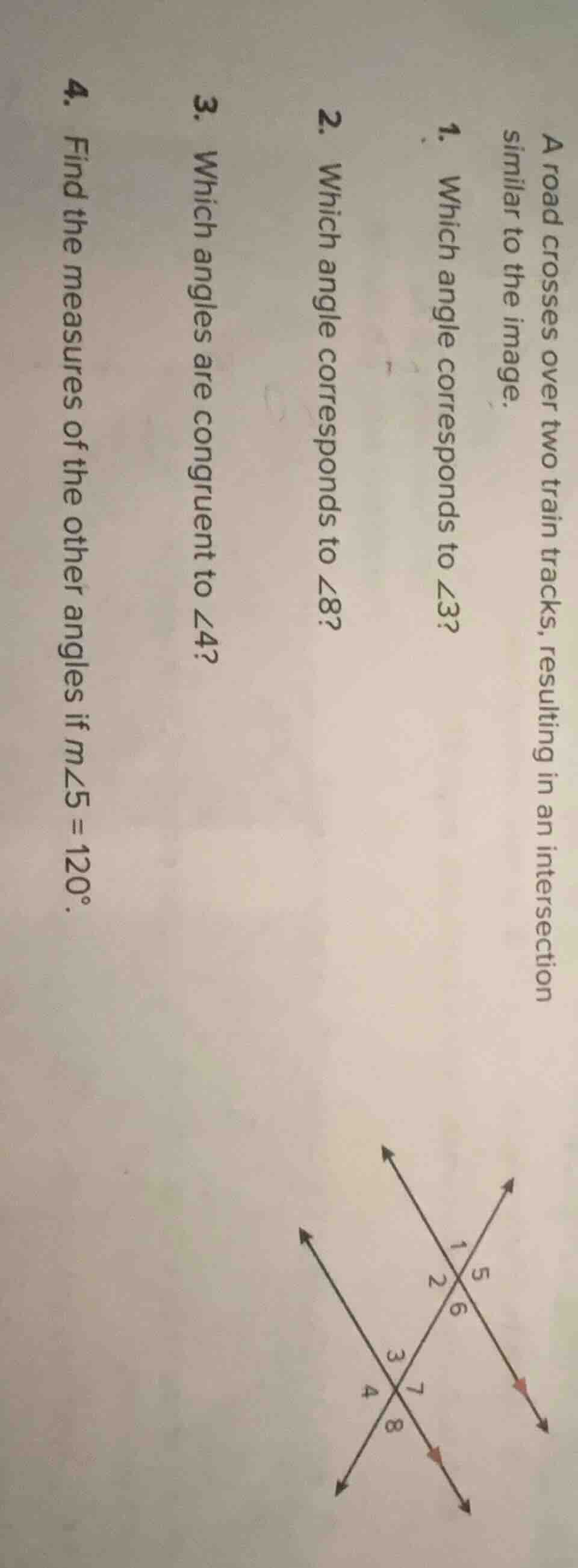 a road crosses over two train tracks, resulting in an intersection simi…