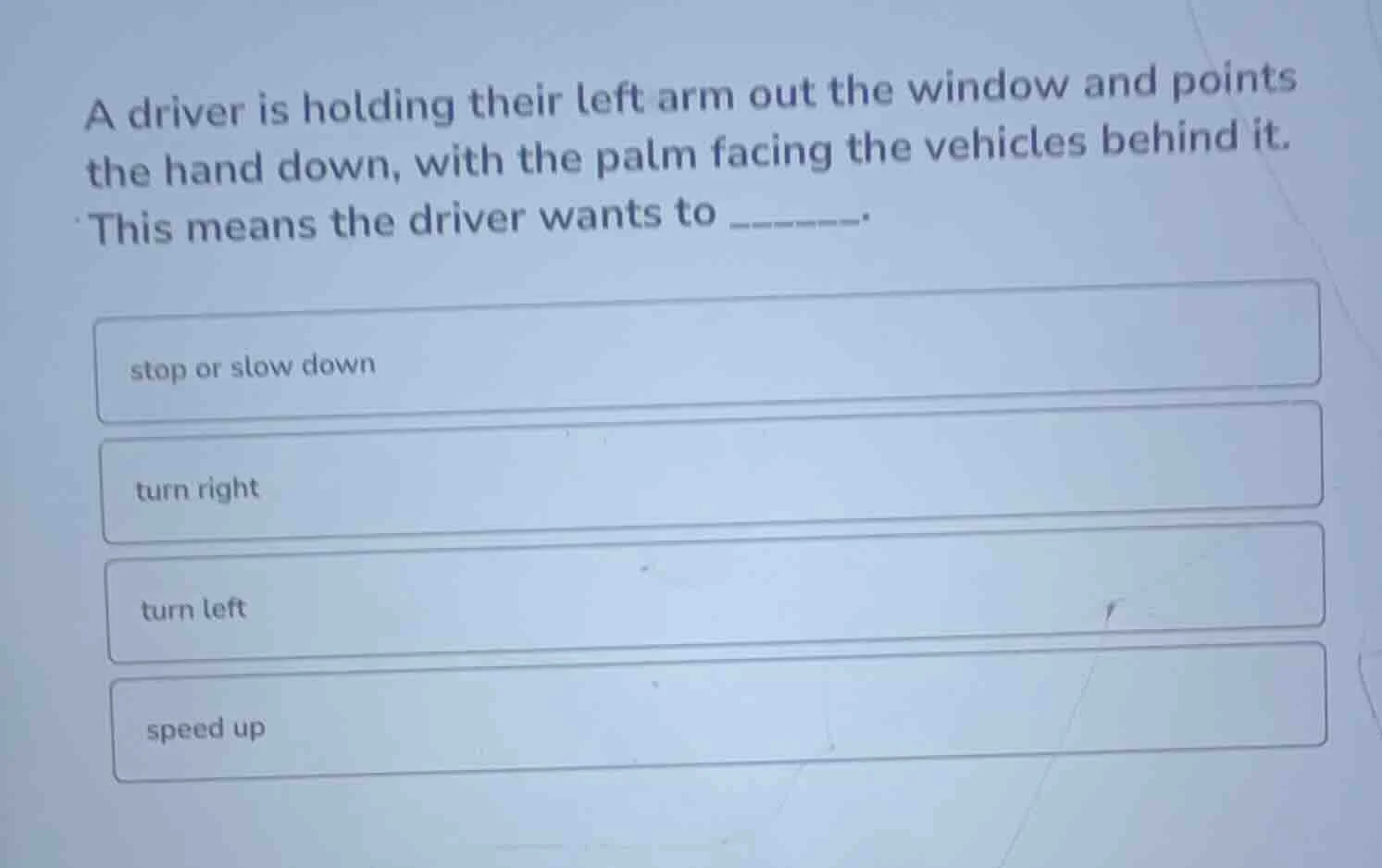 a driver is holding their left arm out the window and points the hand d…