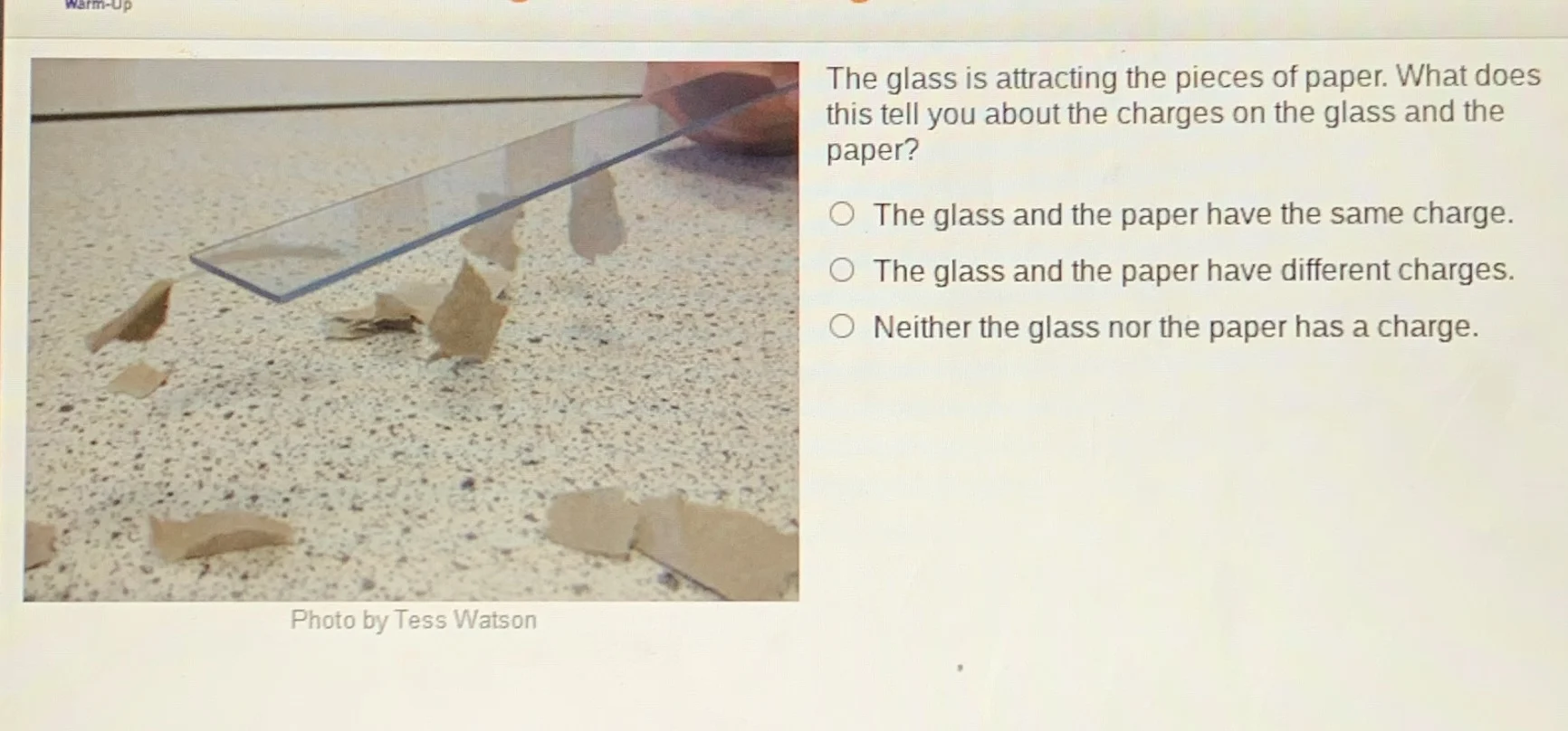 warm-up the glass is attracting the pieces of paper. what does this tel…